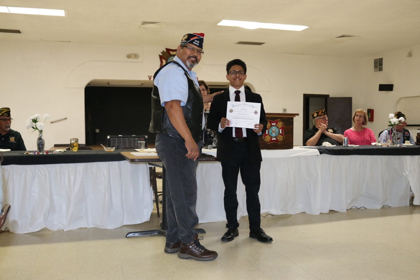 Commander Fernandez presents Nathanial Argueros, the winner of the annual Voice of Democracy essay contest.