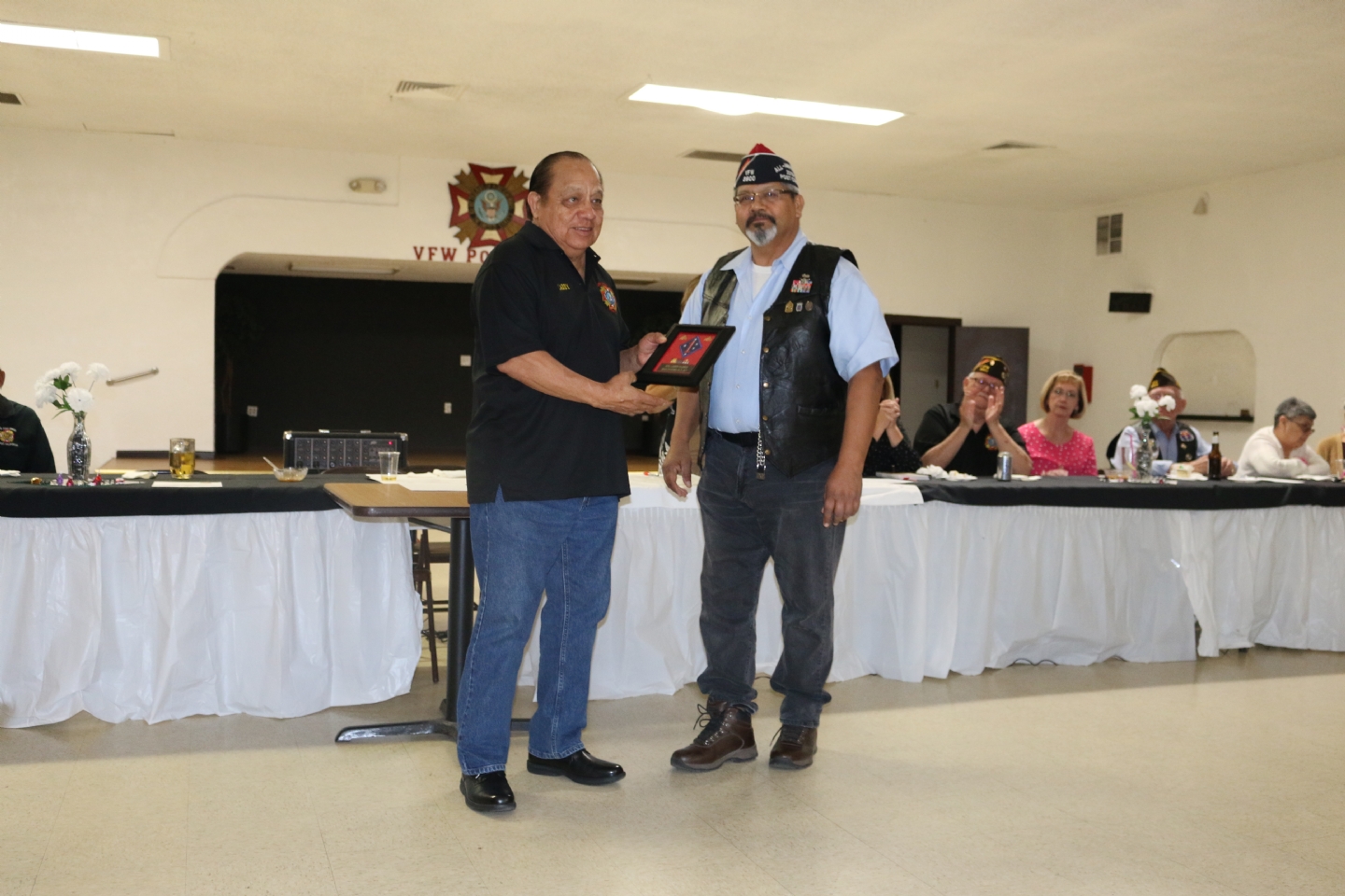 Commander Fernandez presents his Commander's Award to Larry Flores.